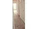 Bright hallway featuring neutral carpet and a partially viewed window at the end at 116 Ventura Trl, Stockbridge, GA 30281