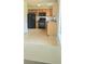 Compact kitchen features black appliances and warm wood cabinetry at 116 Ventura Trl, Stockbridge, GA 30281