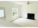 Bright living room featuring a fireplace, ceiling fan, and a large window at 116 Ventura Trl, Stockbridge, GA 30281