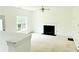 Bright living room featuring a fireplace, ceiling fan, and a large window at 116 Ventura Trl, Stockbridge, GA 30281