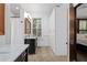 Bathroom with white cabinets, marble countertop and tiled shower with large window at 161 N Barton St, Norcross, GA 30071