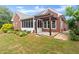 Expansive backyard with lush green grass, mature landscaping, and brick home is perfect for Gathering at 2323 Blackberry Ct, Snellville, GA 30078