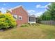 Green backyard features well-kept lawn, beautiful plants, and an inviting patio area great for entertaining at 2323 Blackberry Ct, Snellville, GA 30078