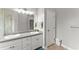 Stylish bathroom with double vanity, sleek countertop, framed mirror, and tiled floors offers modern elegance at 2323 Blackberry Ct, Snellville, GA 30078