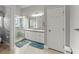 Bright bathroom features a double sink vanity, walk-in shower with glass door, and ceramic tile floors at 2323 Blackberry Ct, Snellville, GA 30078