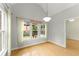 Dining room featuring hardwood floors, a hanging light fixture, and large windows at 2323 Blackberry Ct, Snellville, GA 30078