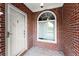 The entry features a sidelight window, security door, and tile flooring at 2323 Blackberry Ct, Snellville, GA 30078