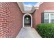 Welcoming entrance showcasing an arched doorway and classic brick design at 2323 Blackberry Ct, Snellville, GA 30078