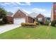 Attractive brick home featuring a green lawn, and manicured landscaping at 2323 Blackberry Ct, Snellville, GA 30078