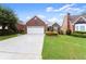 Inviting brick home showcasing a well-kept lawn and beautiful landscaping at 2323 Blackberry Ct, Snellville, GA 30078