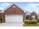 Close up exterior image of a well-maintained brick home with a two-car garage and manicured bushes at 2323 Blackberry Ct, Snellville, GA 30078