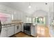 Bright kitchen featuring granite countertops, white cabinets, and stainless steel appliances at 2323 Blackberry Ct, Snellville, GA 30078