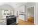 Kitchen boasts granite countertops, white cabinets, and stainless steel stove top at 2323 Blackberry Ct, Snellville, GA 30078
