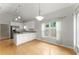 Kitchen featuring granite countertops, white cabinets, stainless appliances, and hardwood floors at 2323 Blackberry Ct, Snellville, GA 30078