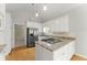 Kitchen featuring granite countertops, white cabinets, and stainless steel refrigerator at 2323 Blackberry Ct, Snellville, GA 30078