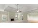 Expansive living room featuring a fireplace, tray ceilings, and abundant natural light at 2323 Blackberry Ct, Snellville, GA 30078