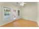 Bright living room featuring hardwood floors, a ceiling fan, and a door to the patio at 2323 Blackberry Ct, Snellville, GA 30078