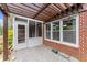 Outdoor patio featuring brick, a pergola, and a doorway leading to screened-in porch at 2323 Blackberry Ct, Snellville, GA 30078