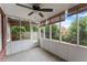 Relaxing screened-in porch with ceiling fan, tongue and groove walls, and views of the landscaped backyard at 2323 Blackberry Ct, Snellville, GA 30078