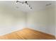 Room featuring hardwood floors, decorative wall panels, and track lighting at 2323 Blackberry Ct, Snellville, GA 30078