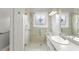 Shower with a gray tiled surround with a flower design window, rain shower head and grab bar at 2323 Blackberry Ct, Snellville, GA 30078