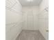 Spacious walk-in closet features ample shelving for storage and organization of your wardrobe and accessories at 2323 Blackberry Ct, Snellville, GA 30078