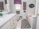 Bright bathroom featuring double sinks, decorative accents and tub with tiled floor at 241 Lost Lake Way, Villa Rica, GA 30180