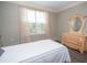 Comfortable bedroom featuring a dresser, mirror and window with natural light at 241 Lost Lake Way, Villa Rica, GA 30180
