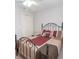 Bedroom with iron-frame bed, neutral walls and carpeted floor at 241 Lost Lake Way, Villa Rica, GA 30180