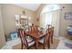 Traditional dining room with wood table set on a jute rug under an arched window at 241 Lost Lake Way, Villa Rica, GA 30180