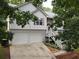 Charming home featuring a two-car garage, stone accents, a cozy front porch, and well-maintained landscaping at 241 Lost Lake Way, Villa Rica, GA 30180