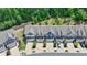An aerial view of newly constructed townhomes, each featuring a private garage and driveway at 315 Duval Dr, Alpharetta, GA 30009