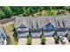 Aerial view of new construction townhomes with garages, landscaping, and brick driveways at 315 Duval Dr, Alpharetta, GA 30009