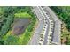 An aerial of a townhome with a pond view, showing the community's proximity to nature and recreational amenities at 315 Duval Dr, Alpharetta, GA 30009