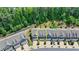 Aerial view of townhome with attached garage surrounded by a wooded landscape in a desirable community at 315 Duval Dr, Alpharetta, GA 30009