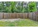 View of fenced backyard with green grass and natural surroundings at 315 Duval Dr, Alpharetta, GA 30009