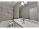 Beautiful bathroom featuring a bathtub with tiled walls and white vanity at 315 Duval Dr, Alpharetta, GA 30009