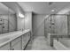 Bright bathroom features dual sinks, tiled floors, a glass shower, and a bathtub at 315 Duval Dr, Alpharetta, GA 30009