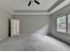 Neutral bedroom featuring tray ceilings, carpeted floors, and bright windows at 315 Duval Dr, Alpharetta, GA 30009