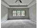 Neutral bedroom featuring tray ceilings, carpeted floors, and bright windows at 315 Duval Dr, Alpharetta, GA 30009