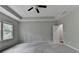 Neutral bedroom featuring tray ceilings, carpeted floors, and bright windows at 315 Duval Dr, Alpharetta, GA 30009