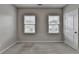 Neutral bedroom featuring plush carpet, natural light, and views of the neighborhood outside at 315 Duval Dr, Alpharetta, GA 30009