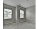 Cozy bedroom with neutral carpet, two windows offering neighborhood views, and plenty of natural light at 315 Duval Dr, Alpharetta, GA 30009