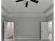 Neutral bedroom featuring tray ceilings, carpeted floors, and ensuite bathroom at 315 Duval Dr, Alpharetta, GA 30009