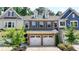 Charming brick townhome featuring a two-car garage and well-maintained landscaping at 315 Duval Dr, Alpharetta, GA 30009