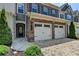 A townhome with a brick facade, two-car garage, and a well-manicured lawn at 315 Duval Dr, Alpharetta, GA 30009