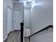 Upstairs hallway with wood-look floors, a modern light fixture, and access to multiple rooms at 315 Duval Dr, Alpharetta, GA 30009