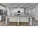 Bright kitchen featuring white cabinets, granite countertops, stainless steel appliances, and a large island at 315 Duval Dr, Alpharetta, GA 30009