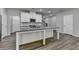 Stylish kitchen featuring a central island, white cabinetry, granite counters, and modern appliances at 315 Duval Dr, Alpharetta, GA 30009