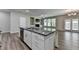 Kitchen island featuring granite countertops and stainless steel dishwasher with view of the Gathering room at 315 Duval Dr, Alpharetta, GA 30009
